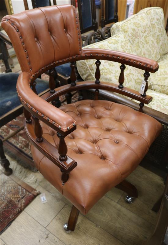 A modern mahogany and buttoned leather desk chair